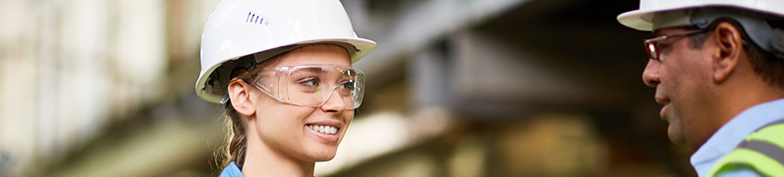 Female construction apprentice talking with instructor