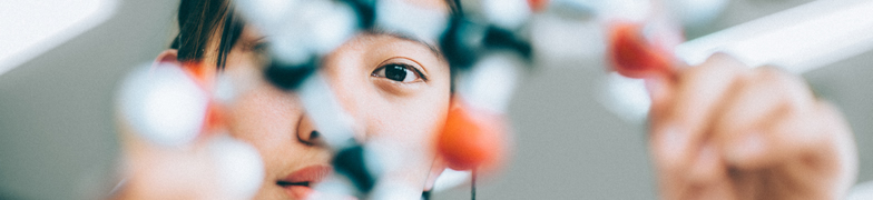 Student holding molecular model